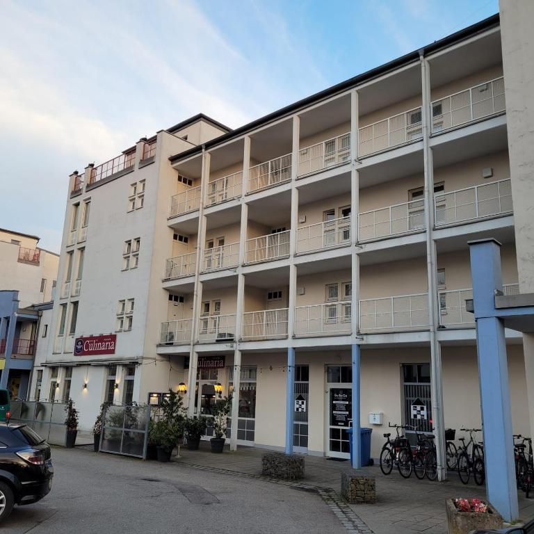 an apartment building with balconies and a parking lot at Ludwigsturm Appartement in Straubing in Straubing
