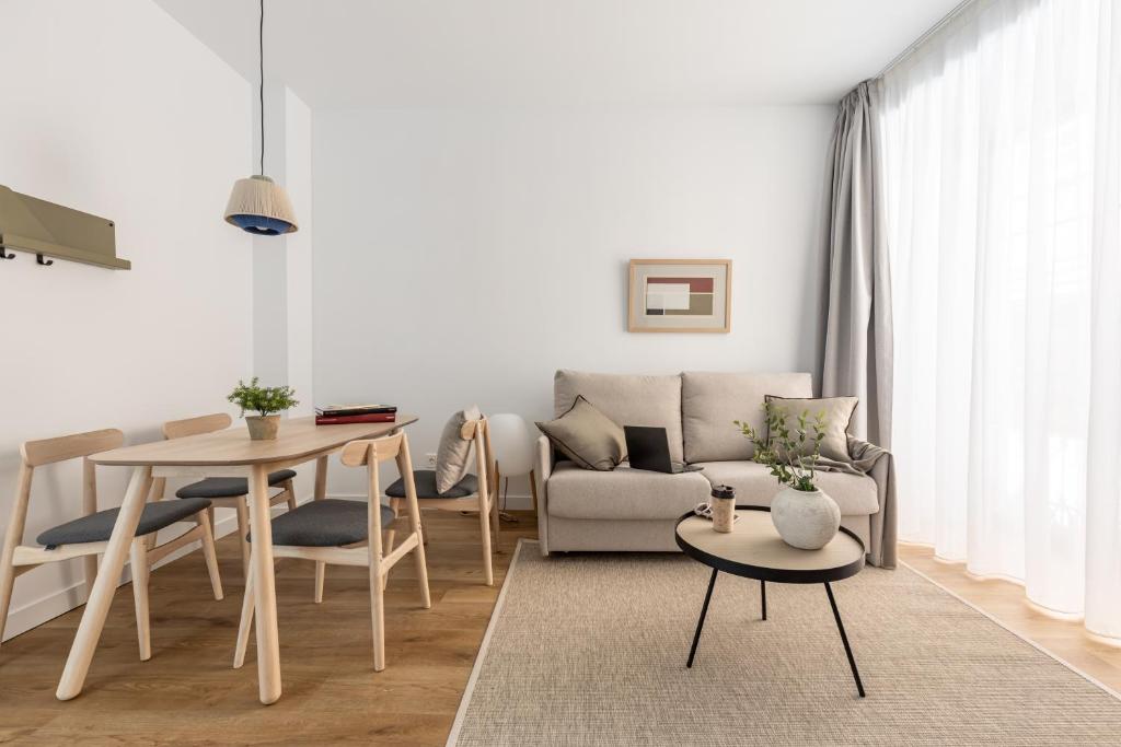 a living room with a couch and a table at Líbere Ciudad Real in Ciudad Real