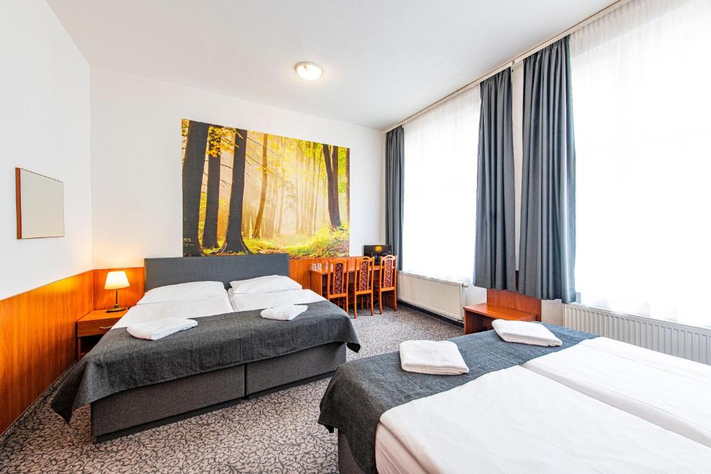 Postel nebo postele na pokoji v ubytování Hotel Zlatá Váha