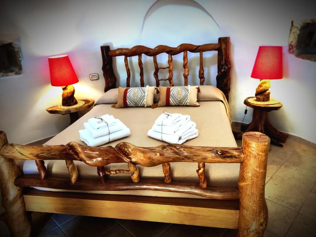 Un pat sau paturi într-o cameră la Masseria Quis Ut Deus