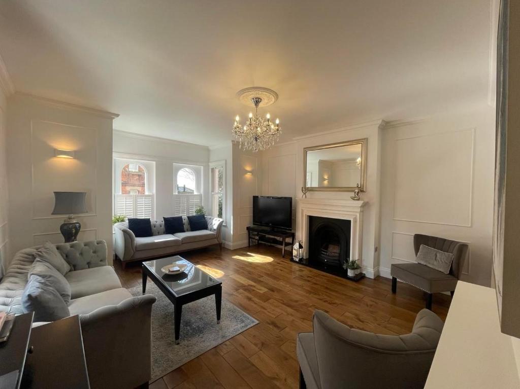 a living room with a couch and a fireplace at Castle View House in Lincolnshire