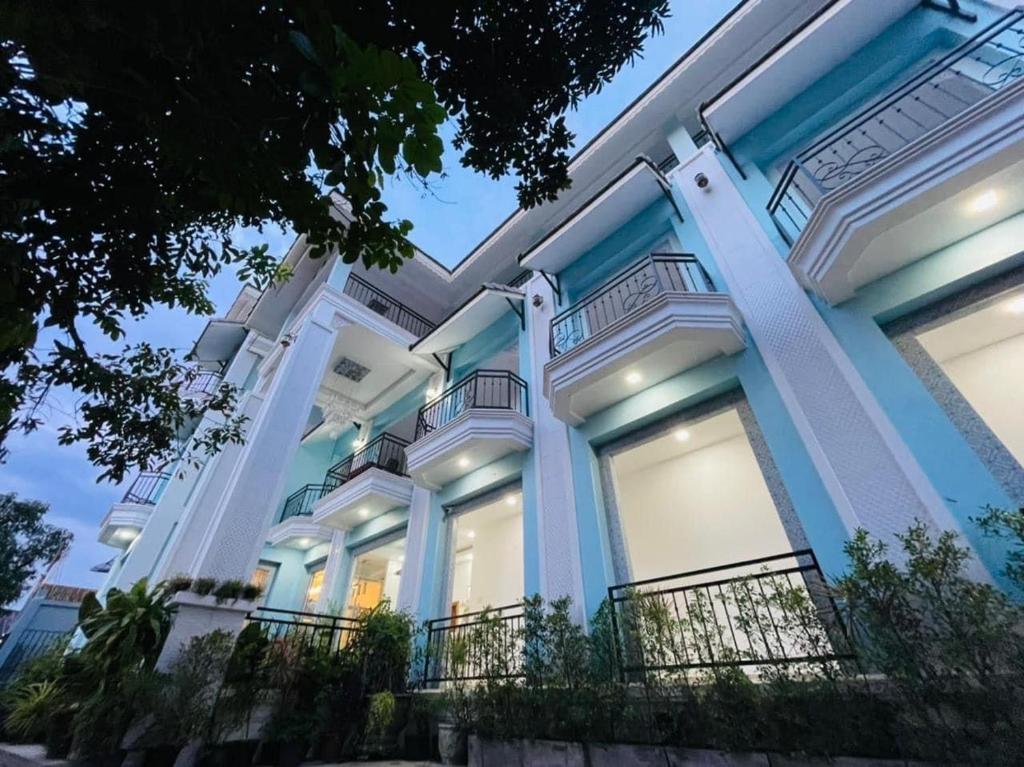 a large blue and white building with columns at VangVieng Crystal Boutique Hotel in Vang Vieng