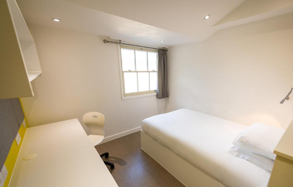a small bedroom with a bed and a window at University of Bath City Accommodation in Bath