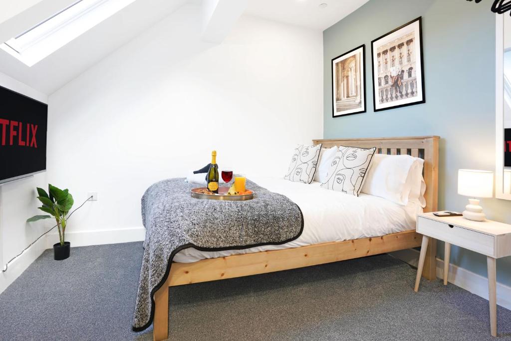 a bedroom with a bed with a table on it at Central Buckingham Apartment #8 with Free Parking, Pool Table, Fast Wifi and Smart TV with Netflix by Yoko Property in Buckingham
