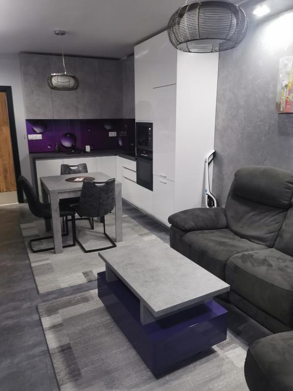 a living room with a couch and a table at Апартамент Светли in Vratsa