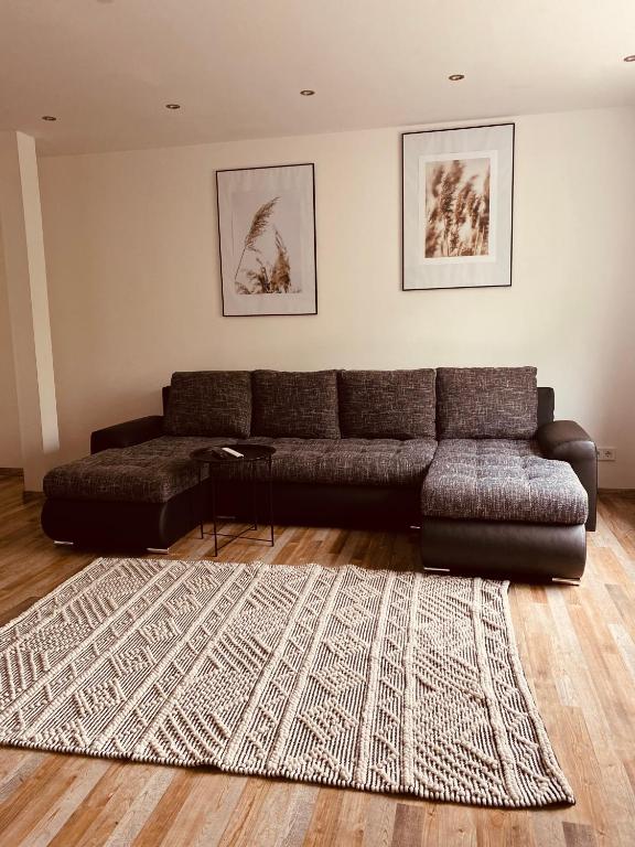 a living room with a couch and a rug at Ferienwohnung Horst 2 in Nordenham
