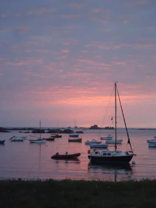 a group of boats in the water at sunset at Kerletty, la mer, les embruns, à 250 m des plages in Plouguerneau