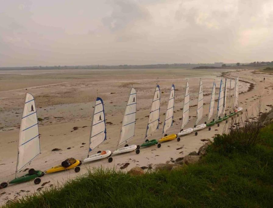 a row of sailboats lined up on a beach at Kerletty, la mer, les embruns, à 250 m des plages in Plouguerneau