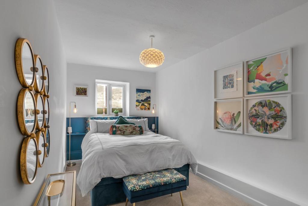 a bedroom with a blue bed and a mirror at Duke Street brand new central 1 bed flat in Norwich