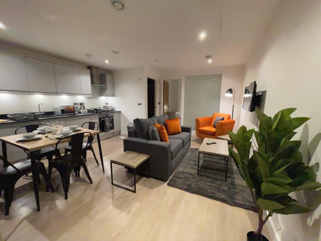 uma sala de estar com um sofá e uma mesa em 1-Bedroom Apartments in the Heart of Central Woking em Woking