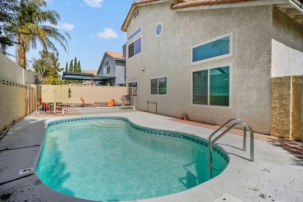 a swimming pool in front of a house at Work, Life, Luxury! Luxe Vegas Home w Firepit+Pool in Las Vegas