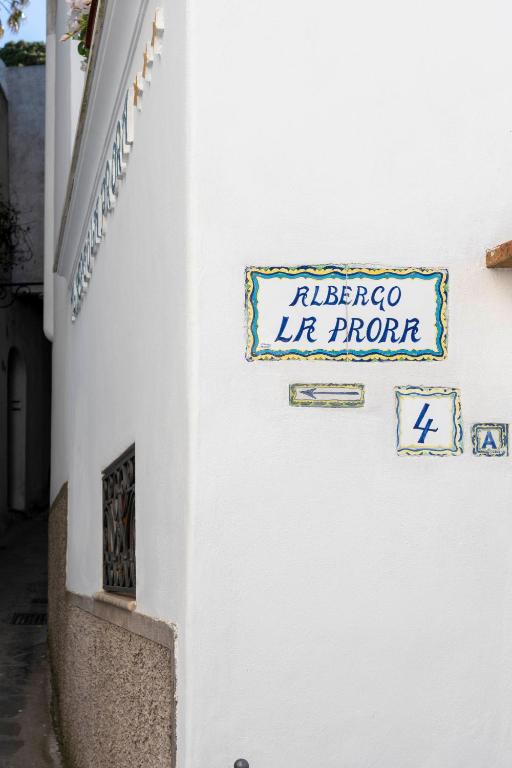 a sign on the side of a building that reads el fuego lift property at Albergo La Prora in Capri