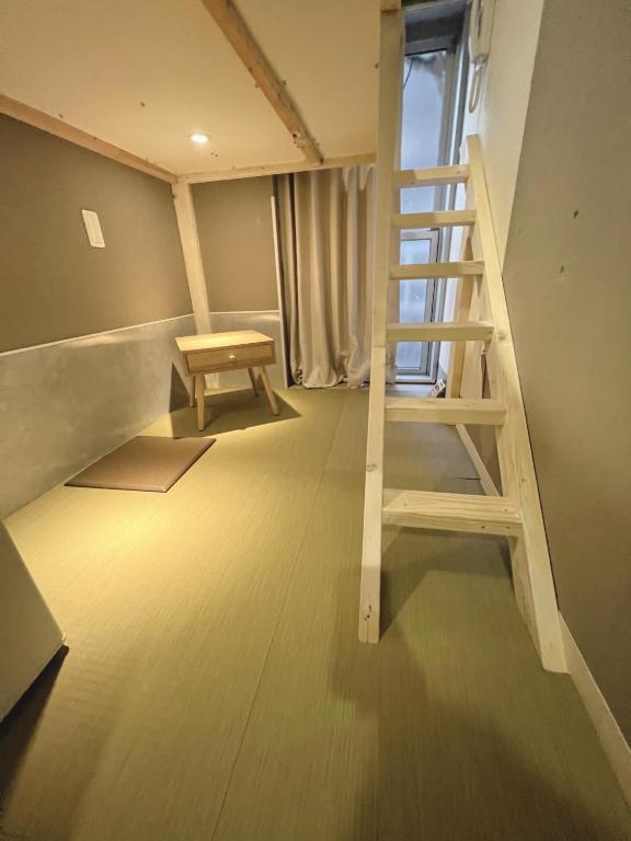 Postel nebo postele na pokoji v ubytování 誠家　MAKOTO HOSTEL