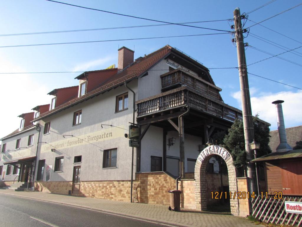 ein großes weißes Gebäude mit Balkon auf einer Straße in der Unterkunft Gästehaus Zur Sorge in Pennewitz