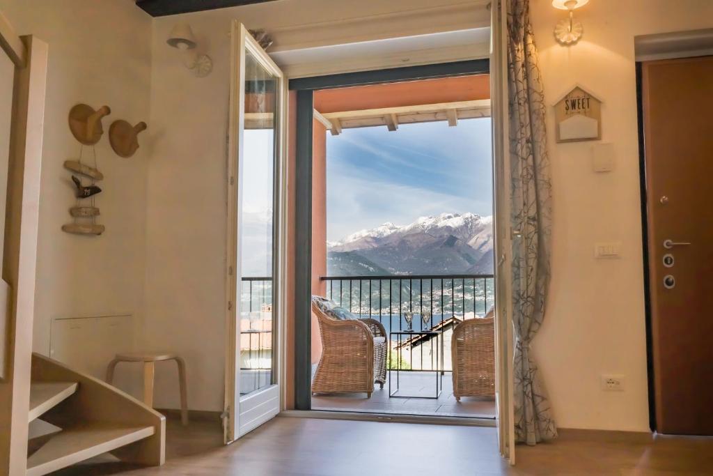 a door leading to a balcony with a mountain view at Casa ALMA in Colico