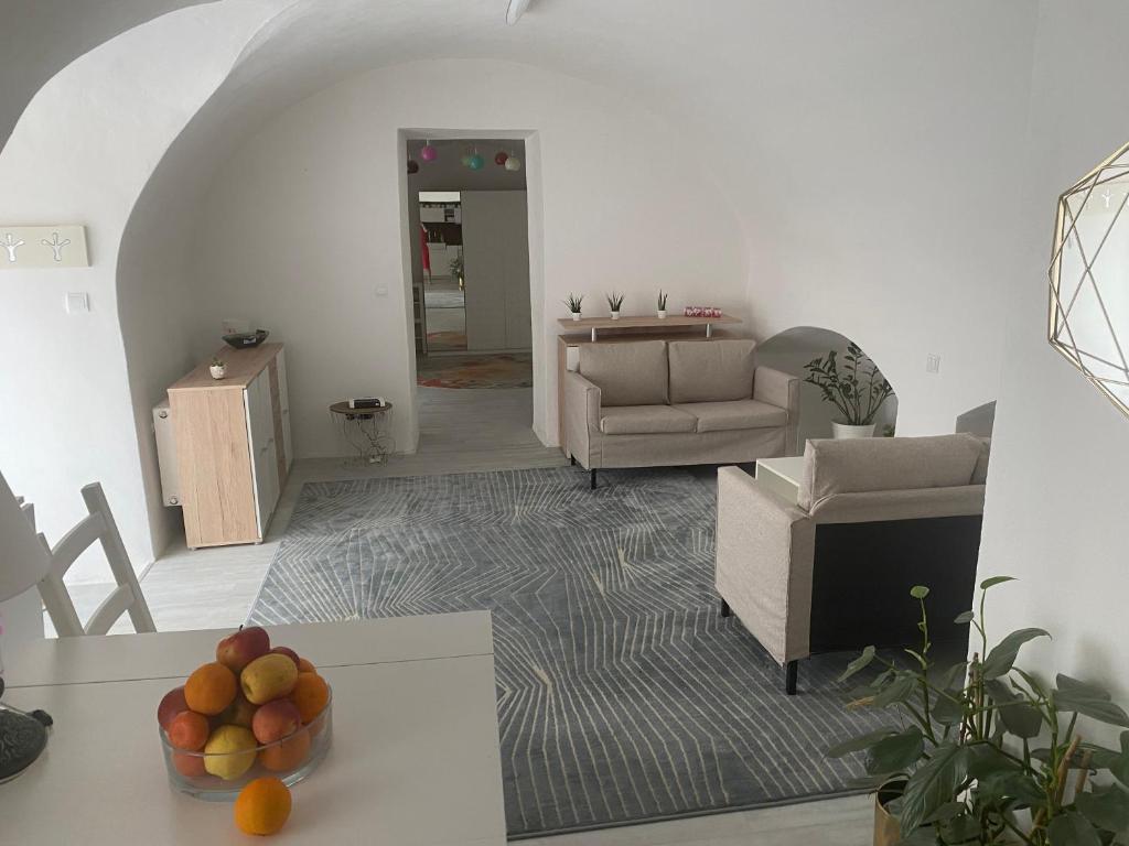 a living room with a bowl of fruit on a table at Apartman Fabrik in Hainburg an der Donau