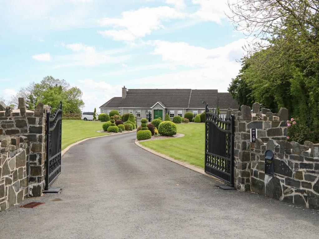 a gate to a house with a driveway at The Hideaway in Magherafelt