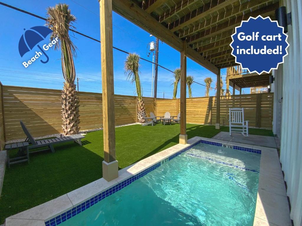 a swimming pool in a yard with palm trees at Dorado Dunes #D Newly Built, Gorgeous Beach Home, Private Pool, Golf Cart Entire Stay in Port Aransas