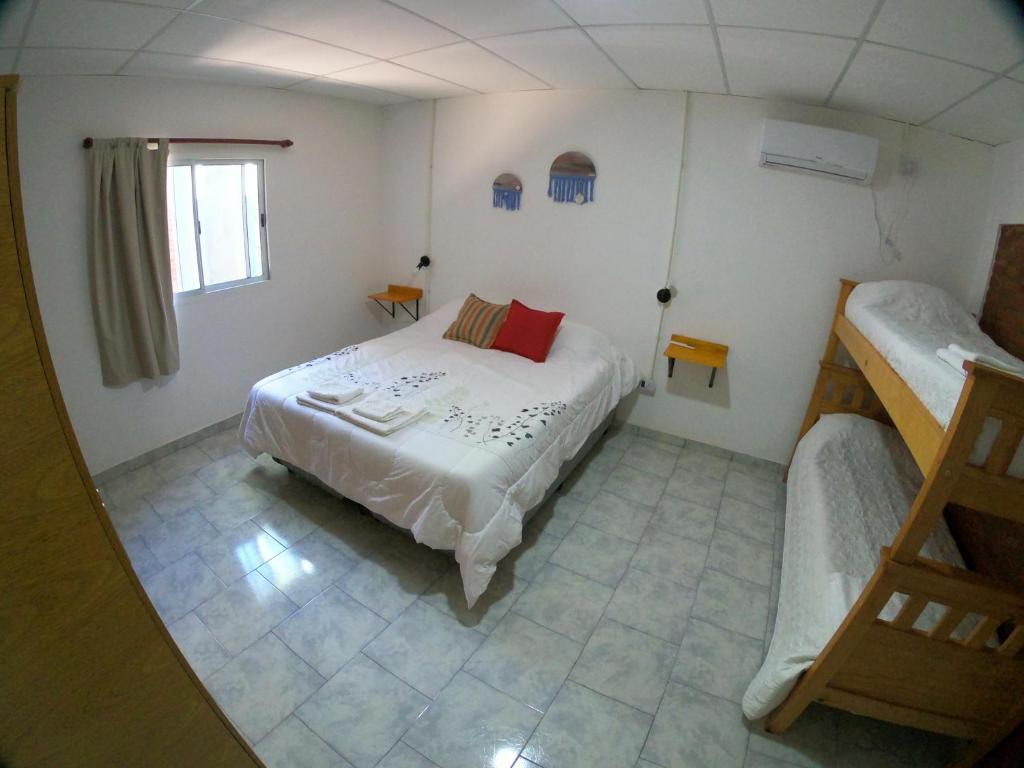 a small bedroom with a bed and a window at Las Catalinas cabañas in San Fernando del Valle de Catamarca
