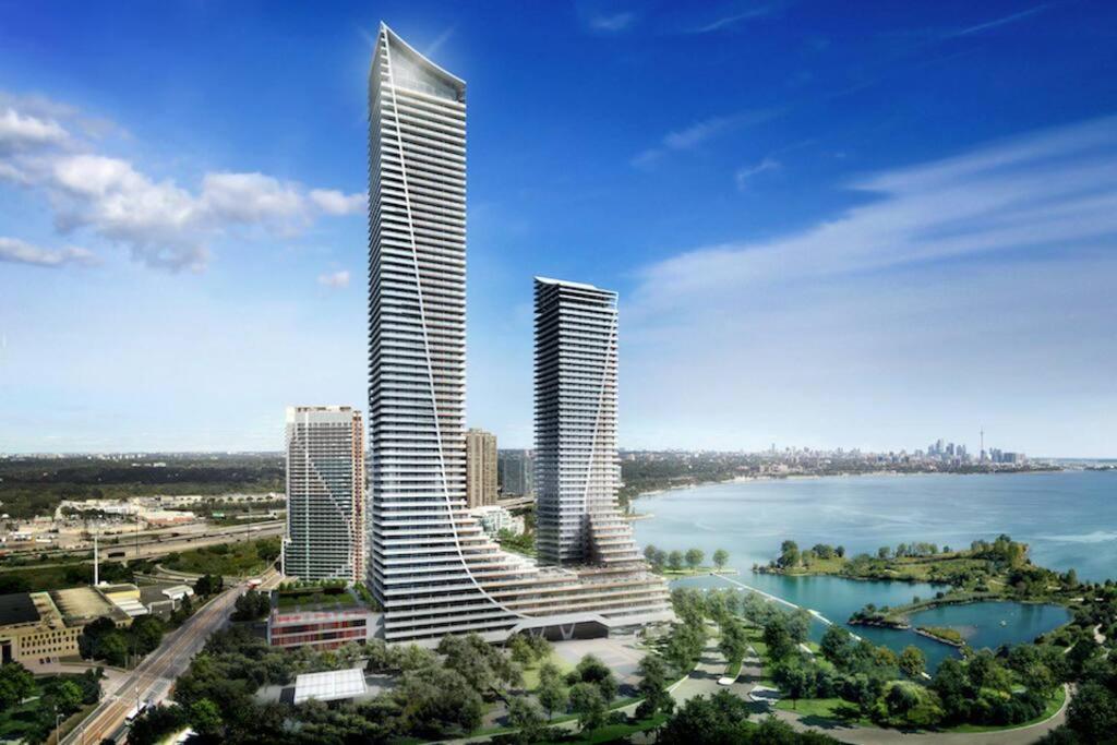 a rendering of a tall building next to a body of water at Waterfront Luxury Condo in Toronto