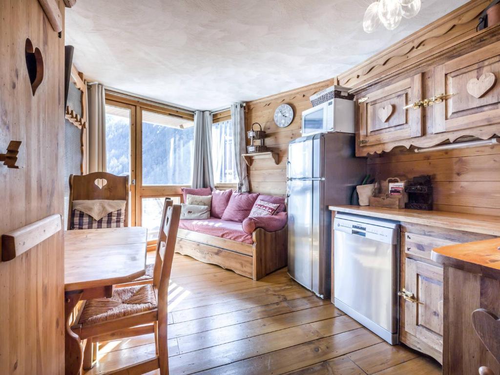 a kitchen with a table and a couch in a room at Studio Val-d'Isère, 1 pièce, 4 personnes - FR-1-694-126 in Val-d'Isère