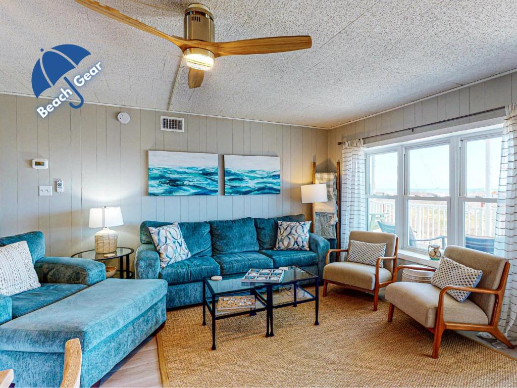a living room with a blue couch and chairs at IR104 3BR Condo w Gulf View, Shared Pools, Boardwalk in Port Aransas