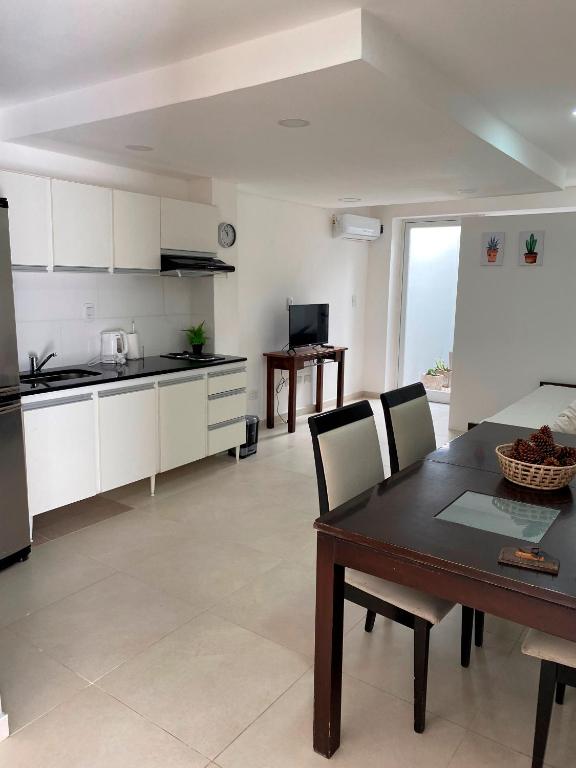 a kitchen and dining room with a table and chairs at Estudio in San Pedro