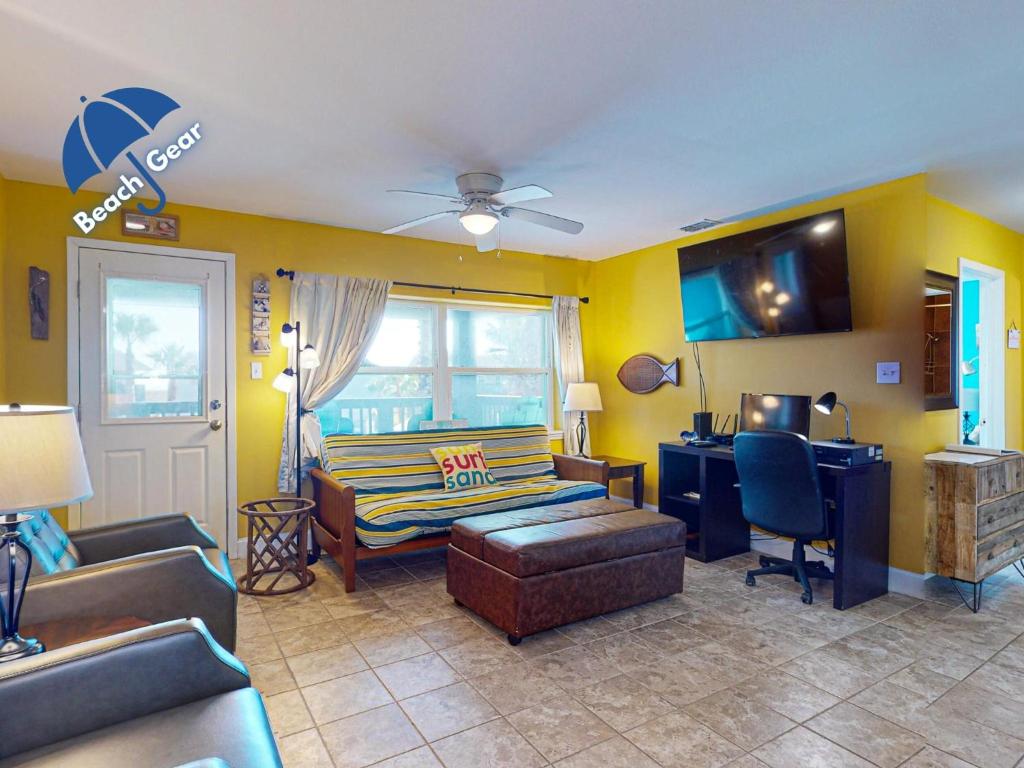 a living room with a couch and a desk at SIV10 Beautiful Condo, Shared Pool, Close to Beach in Port Aransas