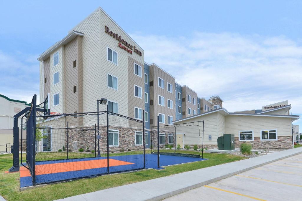 a basketball court in front of a building at Residence Inn by Marriott Champaign in Champaign