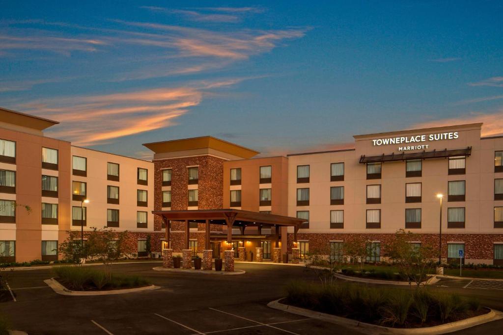 a hotel building with a gazebo in a parking lot at TownePlace Suites by Marriott Foley at OWA in Foley