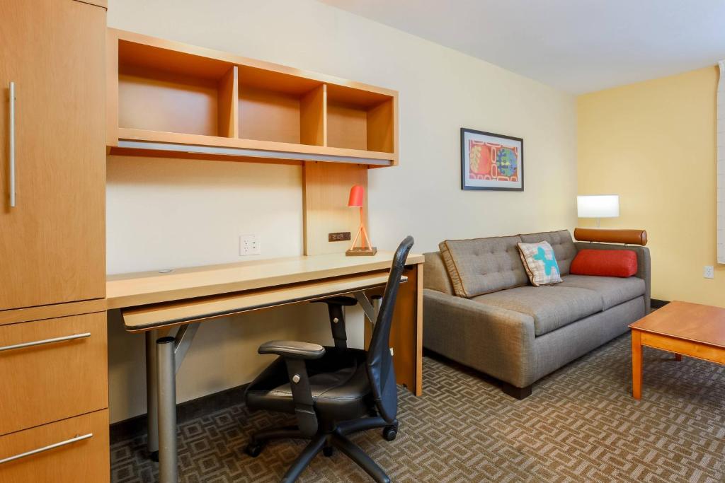 a living room with a desk and a couch at TownePlace Suites by Marriott College Station in College Station