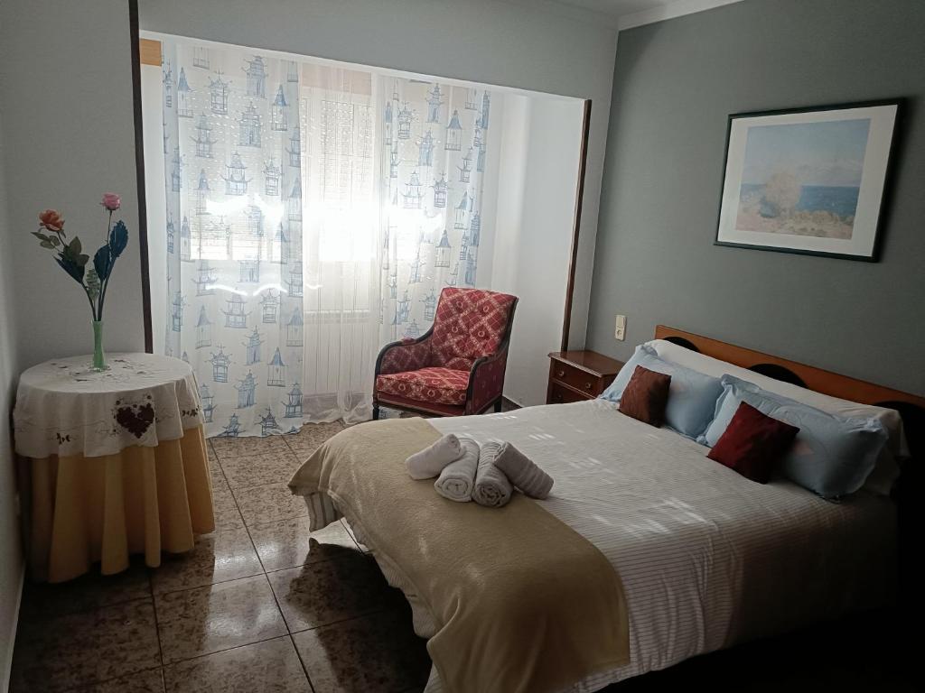 a bedroom with a bed with two towels on it at Buen camino in Santiago de Compostela
