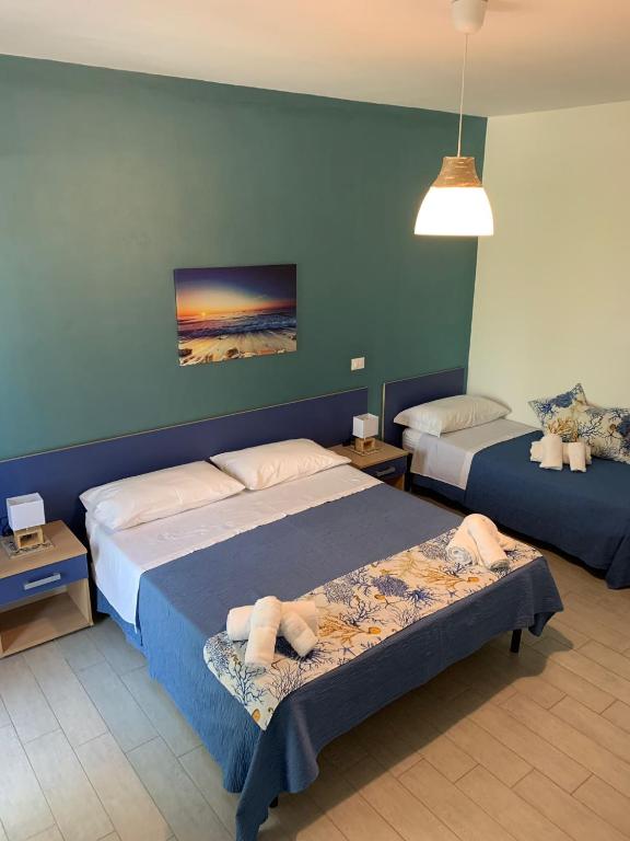 Postel nebo postele na pokoji v ubytování Giostemar Rooms - Playa Grande