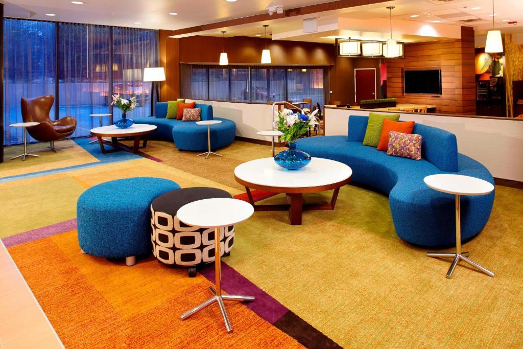 a lobby with blue couches and chairs and tables at Fairfield Inn & Suites Parsippany in Parsippany