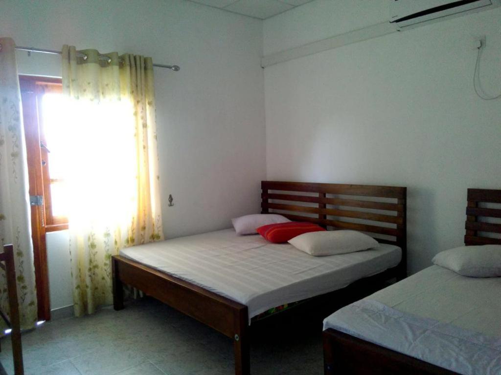 Postel nebo postele na pokoji v ubytování Kumudu Holiday Home
