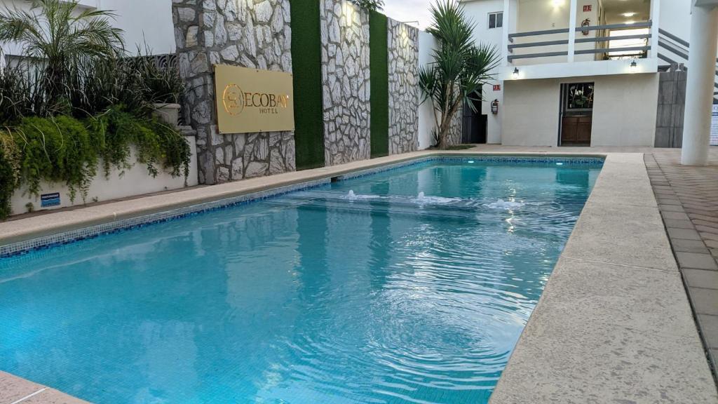 a swimming pool in front of a building at Eco Bay Hotel in Bahía Kino