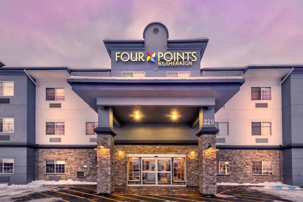 a front view of a four point points ambassador hotel at Four Points by Sheraton Anchorage Downtown in Anchorage