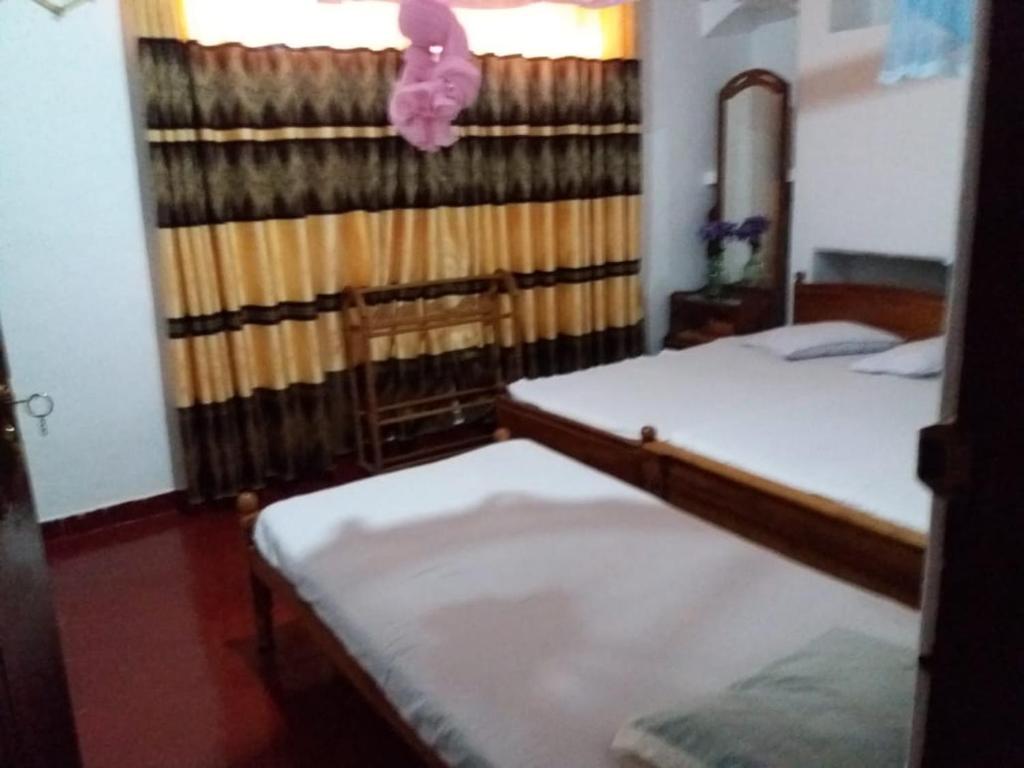 Postel nebo postele na pokoji v ubytování Kumudu Holiday Home