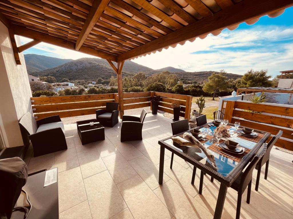 a patio with a table and chairs and a view at Résidence Casa Toga in Galeria