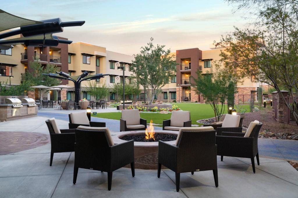 eine Terrasse mit Stühlen und einer Feuerstelle im Innenhof in der Unterkunft Residence Inn by Marriott Scottsdale Salt River in Scottsdale