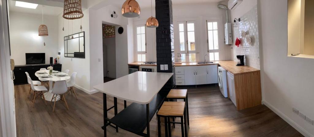 a kitchen and dining room with a white table and chairs at Gorgeous apartment San Telmo up to 6 people in Buenos Aires