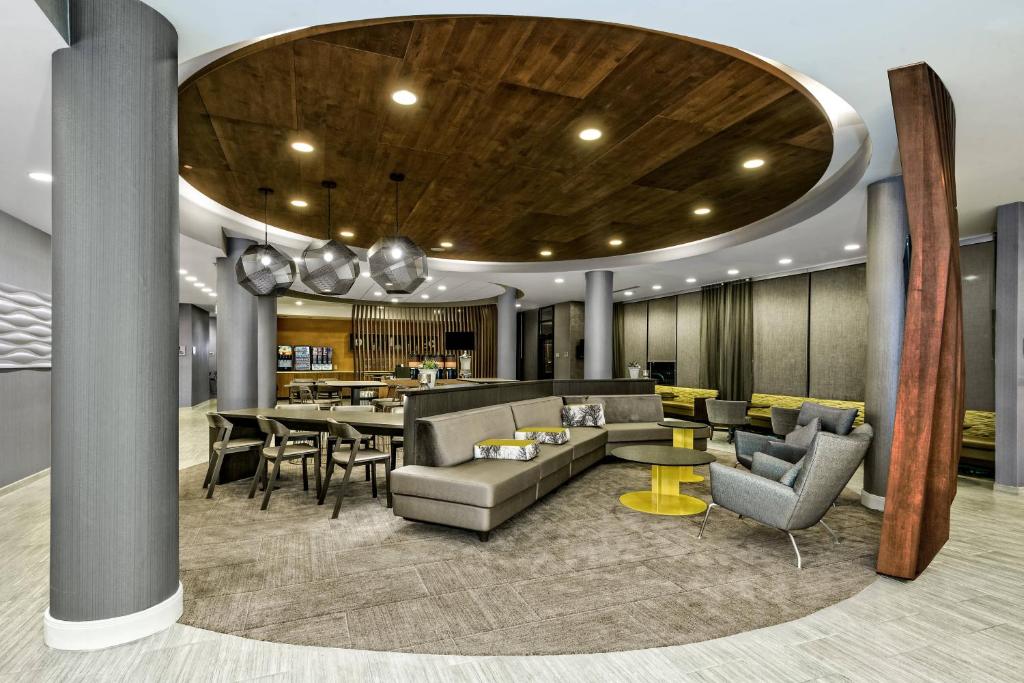 a lobby with a couch and chairs and a table at SpringHill Suites by Marriott San Antonio Airport in San Antonio