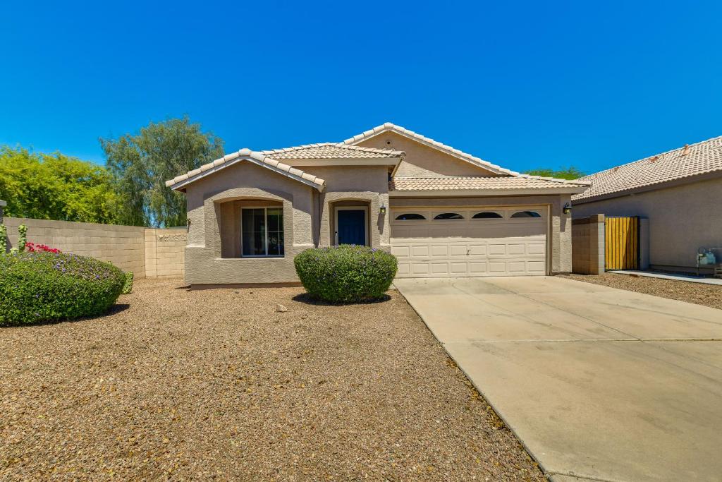 a house with a driveway in front of it at 5 Mi to Dtwn Gilbert Home with Pool and Patio in Gilbert