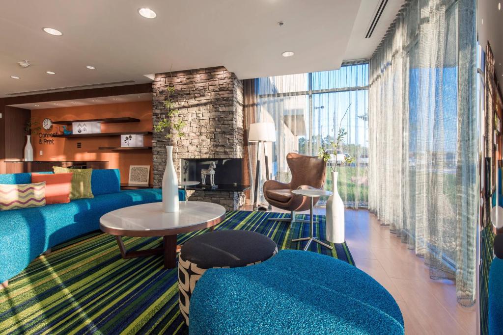 萊文沃斯的住宿－萊文沃斯萬豪費爾菲爾德酒店及套房，客厅设有蓝色的沙发和壁炉