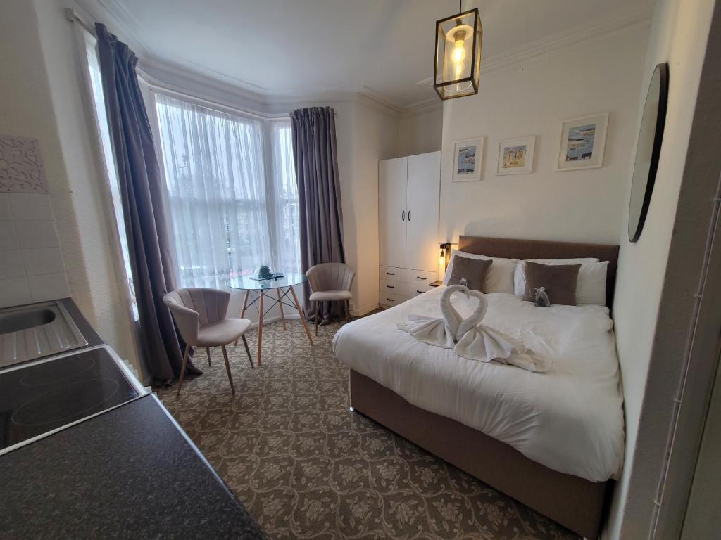 Seaside ground floor flat WIFI & FREE parking في سكرابورو: غرفة الفندق بسرير وطاولة