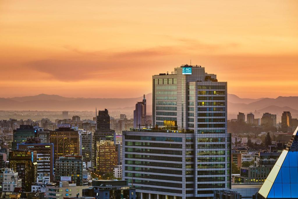 a view of a city skyline at sunset at AC Hotel by Marriott Santiago Costanera Center in Santiago