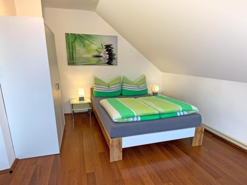 a bedroom with a bed with green pillows at Jacky & Daniel's Apartments Top 2 in Sankt Pölten