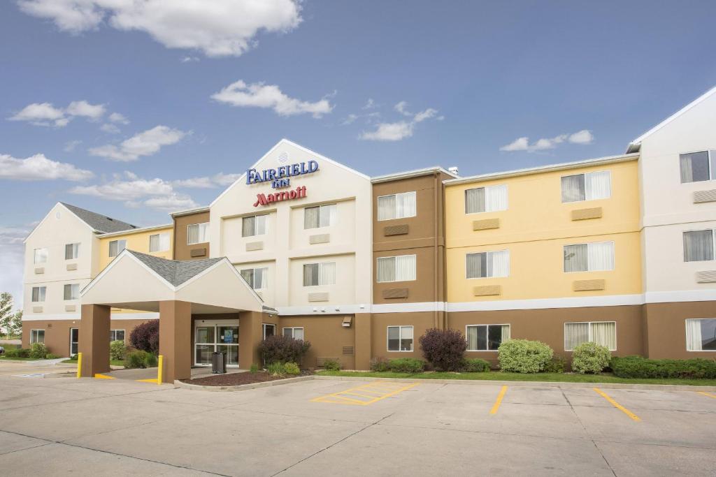 a hotel with a sign on the front of it at Fairfield Inn & Suites Greeley in Greeley