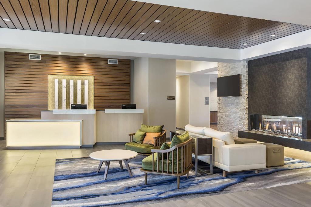 a lobby with a waiting area with a fireplace at Fairfield Inn & Suites by Marriott Minneapolis North/Blaine in Blaine