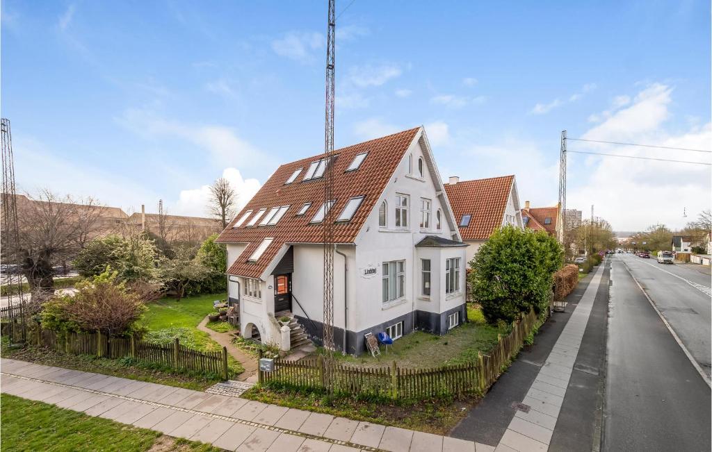a white house on the side of a street at Beautiful Apartment In Aarhus C With Wifi in Aarhus